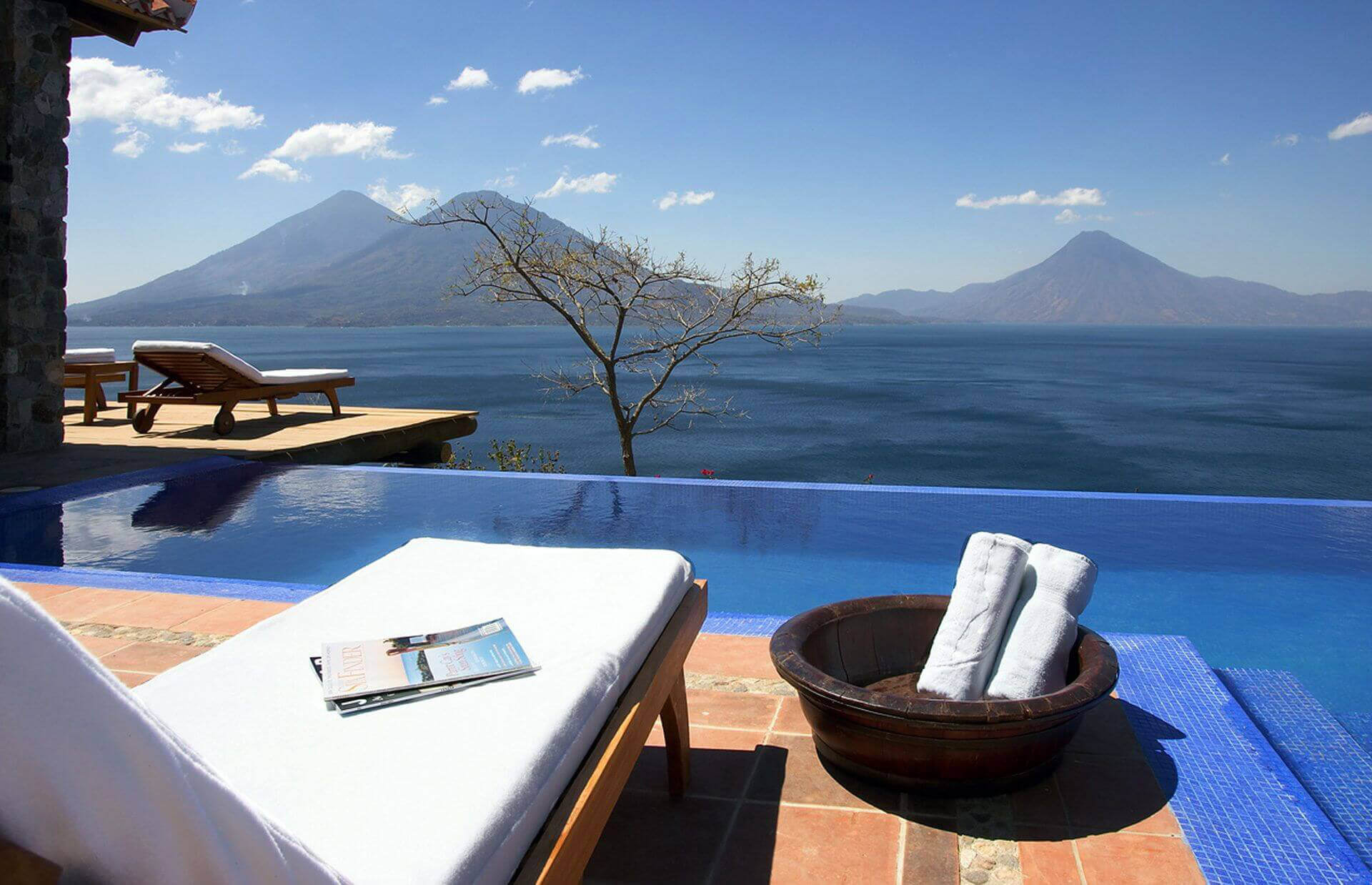 Relax by an infinity pool with views of the mountains and Lake Atitlan