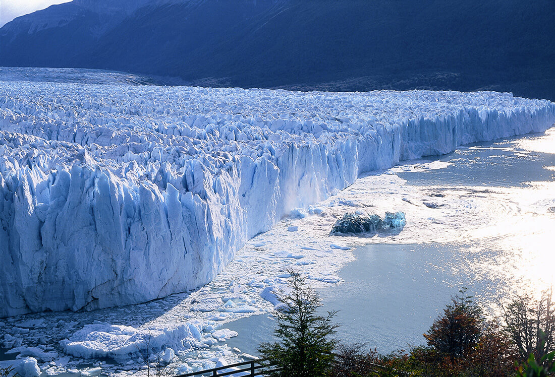 View looking out onto huge Perito Moreno glacier where it ends in Lago Argentino