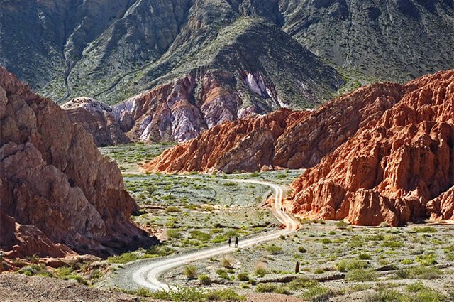Road winding between colorful mountains near Purmamarca, Argentina