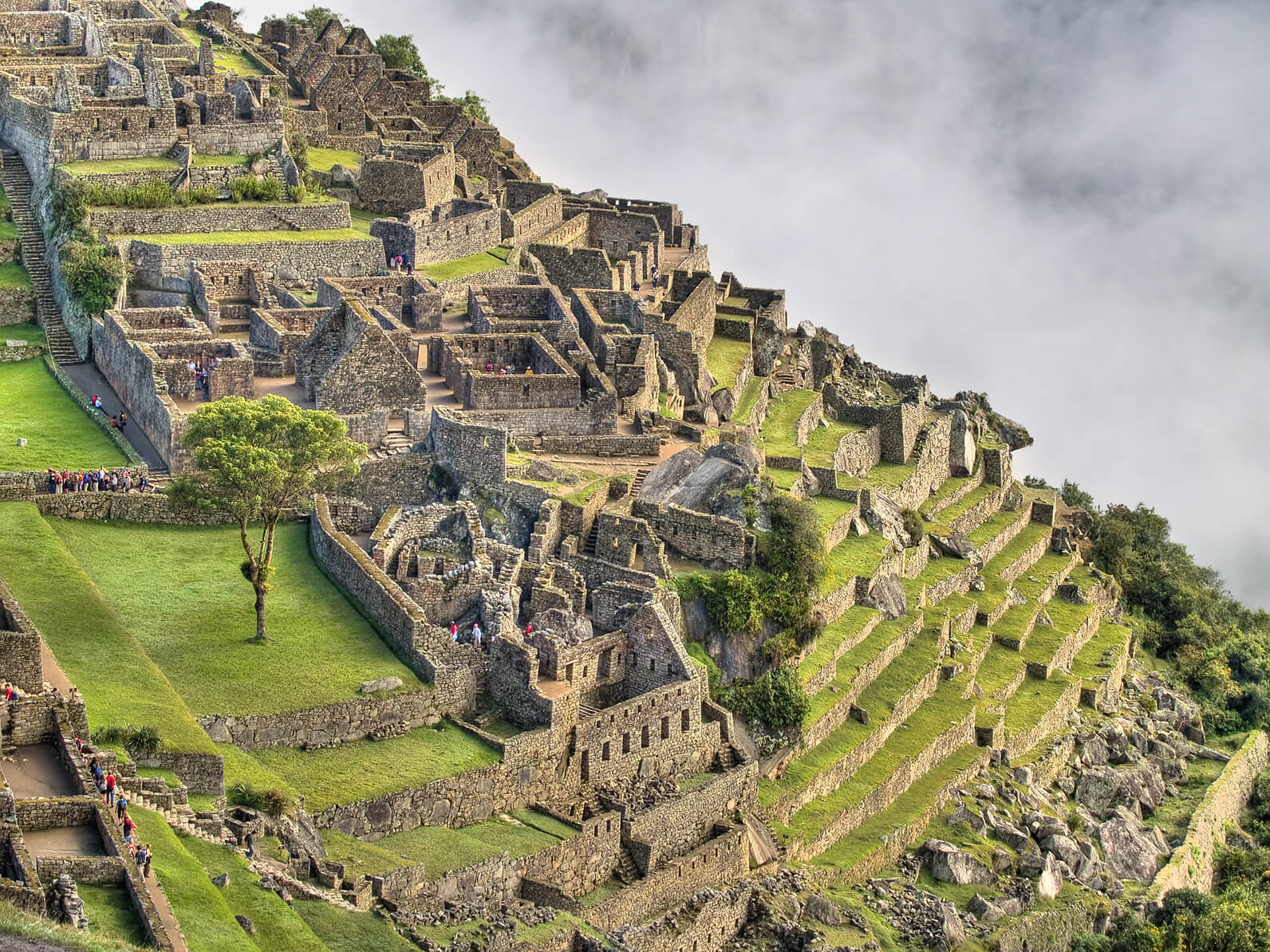 View of the side of Machu Picchu against misty cloud on a luxury Peru tour
