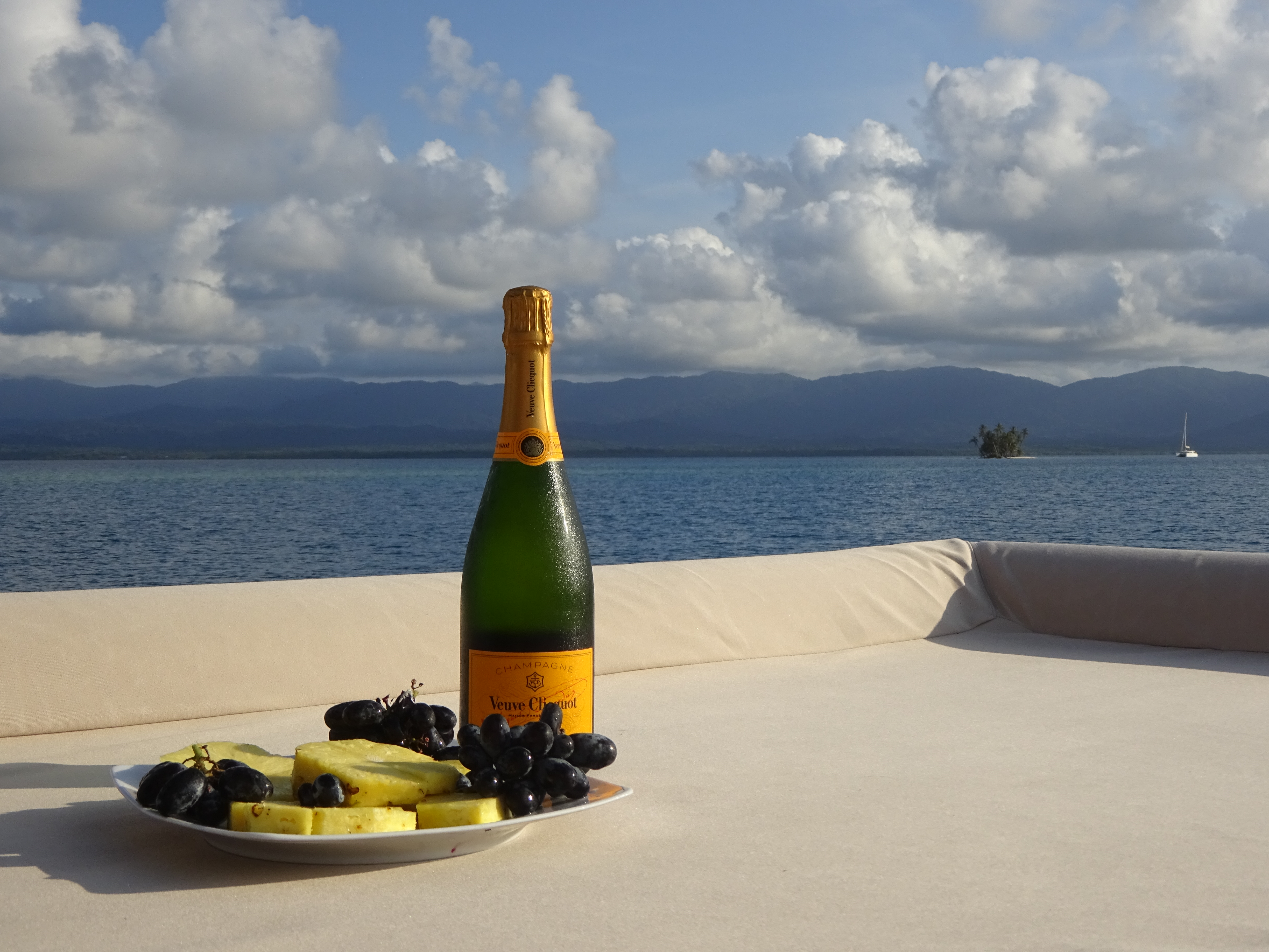 Champagne and fruit on the deck of a private yacht with sea views in Panama's San Blas Islands