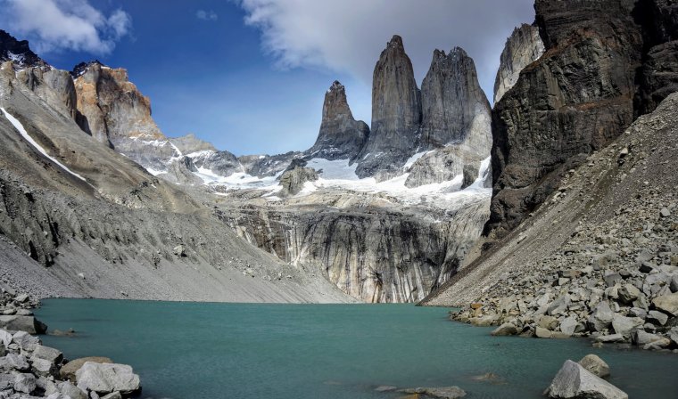 Bright turquoise lake at the base of the jagged peaks of the Towers in Torres del Paine