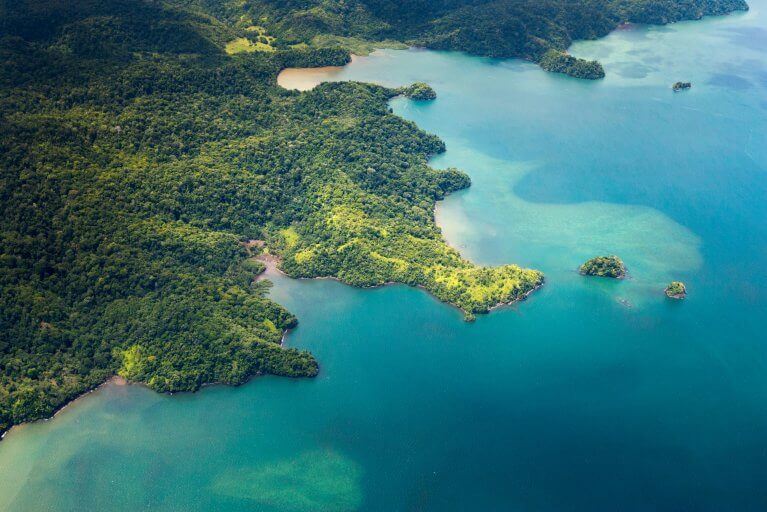 The lush rainforest meets the turquoise waters of the Pacific in an aerial view of the Osa Peninsula