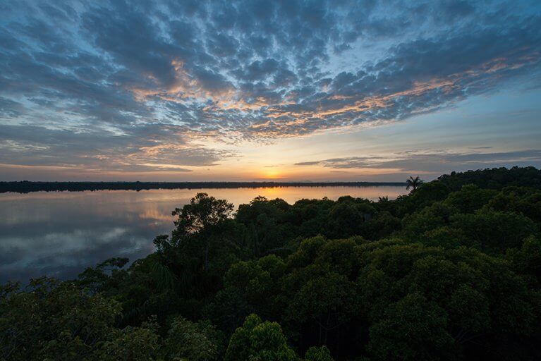 Sunset over the Amazon river and jungle from Anavilhanas Lodge during luxury tour