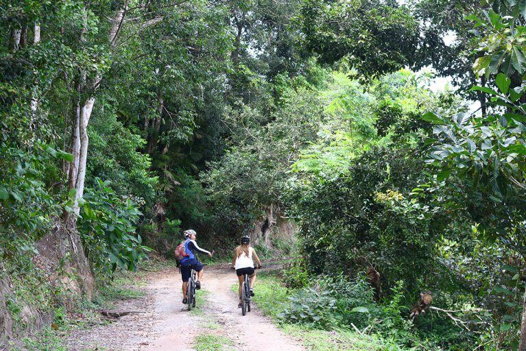 Two people on a private biking excursion in the jungle outside of Trancoso during a luxury Brazil trip