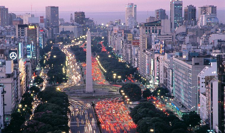 Sunset aerial view of traffic and buildings along Avenida 9 de Julio and around the Obelisk in Buenos Aires