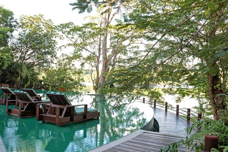Lounge chairs in the outdoor pool at Las Lagunas, a luxury hotel in Peten, Guatemala