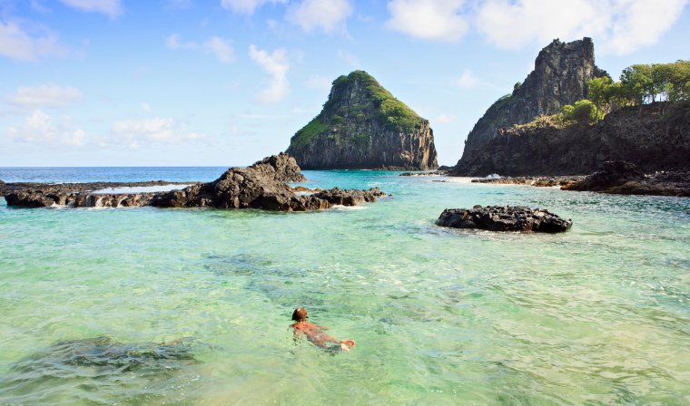 Boy snorkelling in clear waters of Fernando de Noronha during luxury Brazil tour
