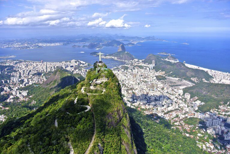 Aerial shot of Christ the Redeemer with Sugarloaf Mountain in the distance in Rio de Janeiro on a luxury Brazil tour