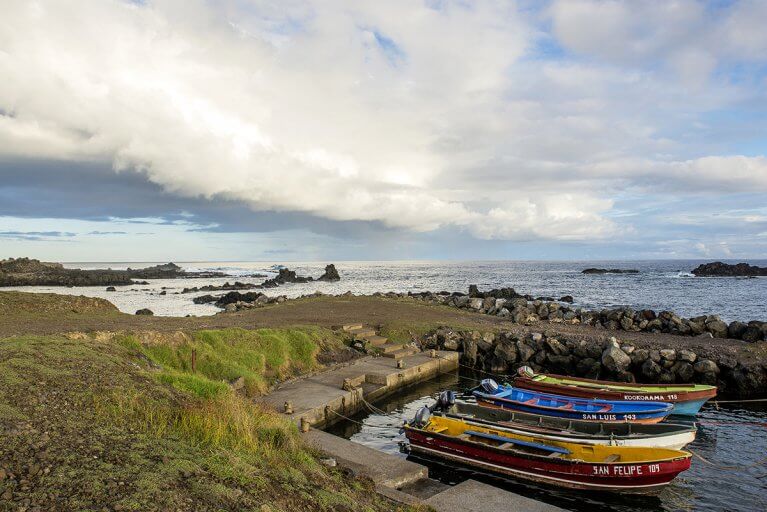 Small, colorful boats docked on Easter Island