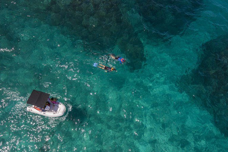 Aerial view of a couple snorkeling during a private boating excursion in Costa Rica's Osa Peninsula