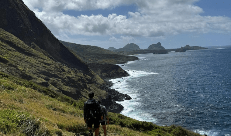 People hiking along coast in Fernando de Noronha in Brazil