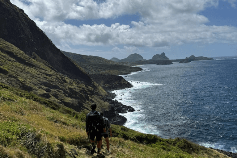 People hiking along coast in Fernando de Noronha in Brazil