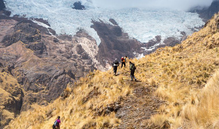 Small group of people enjoying a private hiking tour in Peruvian mountains