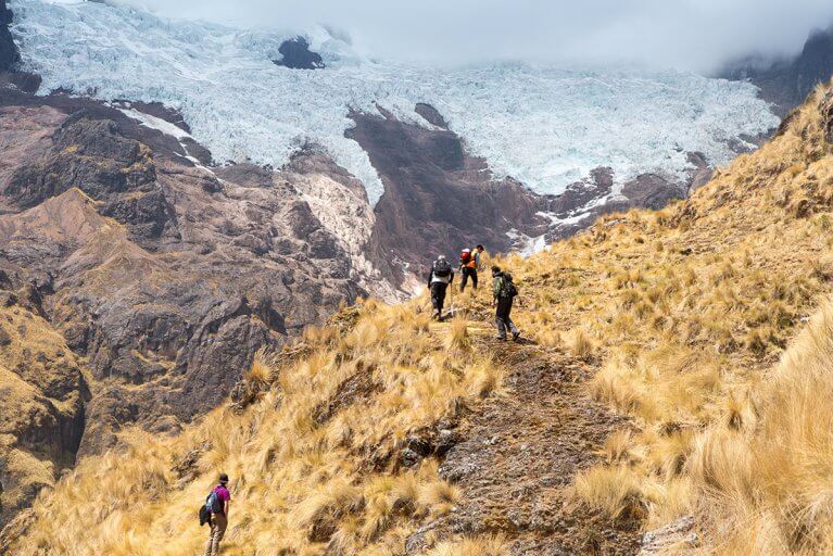 Small group of people enjoying a private hiking tour in Peruvian mountains