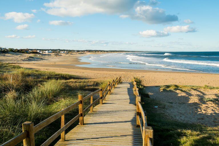 Wooden path leading across dunes to La Pedrera Beach in Rocha, Uruguay