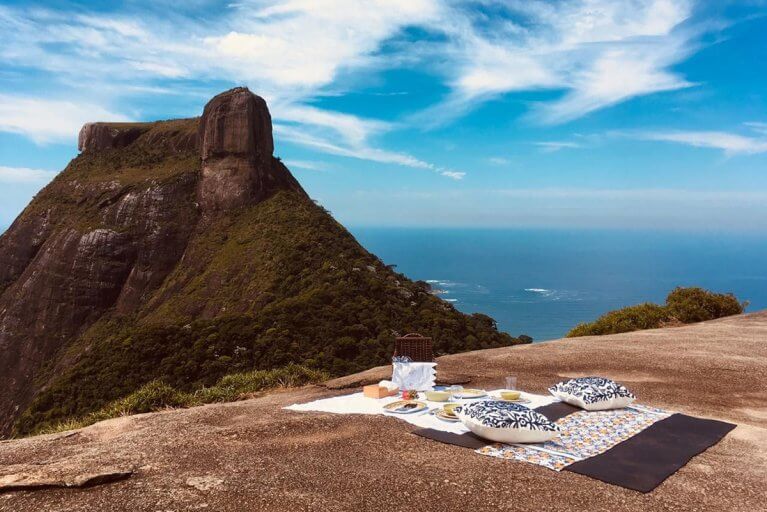 Private gourmet picnic set up with a view of Pedra Bonita in Rio de Janeiro during a luxury tour of Brazil