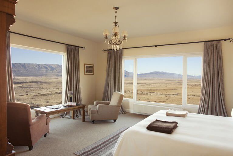 Luxury Suite at Eolo Hotel in Patagonia with views of the mountains and grassland outside
