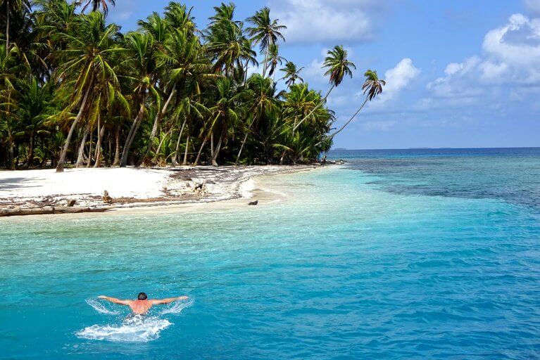 Swimming in turquoise Caribbean waters during a private luxury tour of the San Blas Islands
