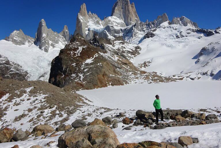 A man pauses while trekking up the snowy Mount Fitz Roy in Argentinian Patagonia