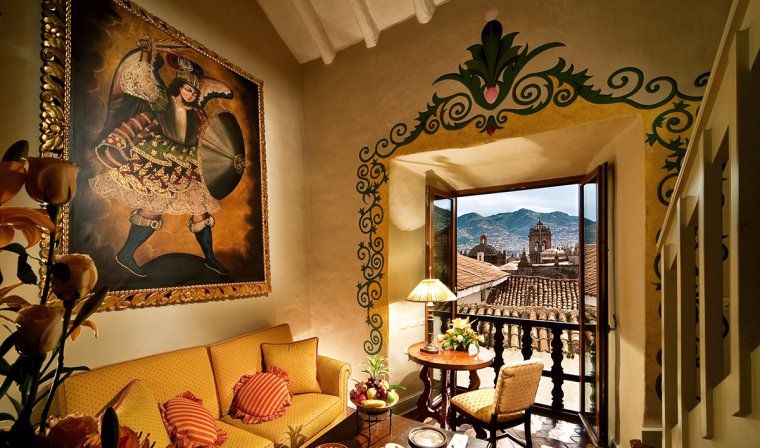 Luxury suite featuring colonial decor and a view of Cusco at the Monasterio Hotel