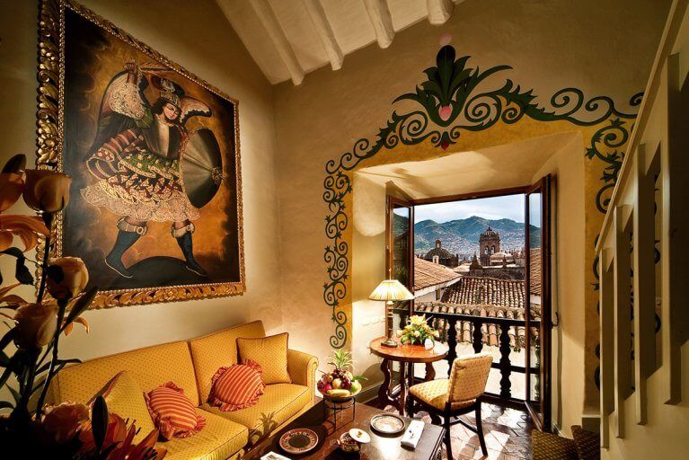 Luxury suite featuring colonial decor and a view of Cusco at the Monasterio Hotel