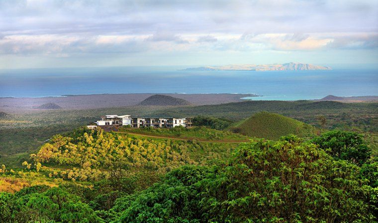 Luxury Pikaia Lodge from afar surrounded by nature with ocean in background in Galapagos Islands