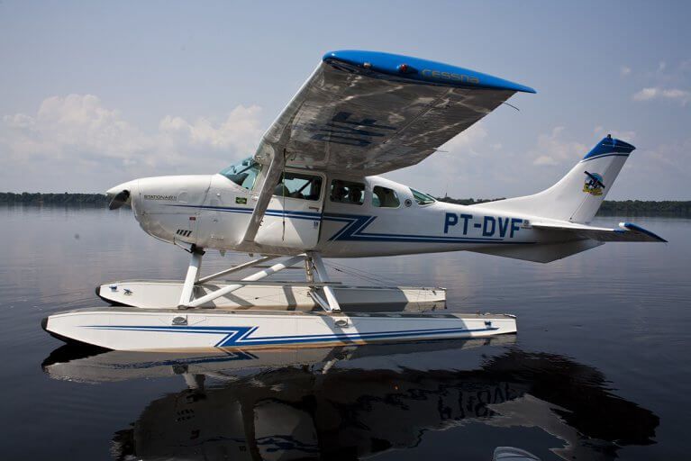 Floatplane used for private transfers to eco lodges in jungle sits on Amazon river