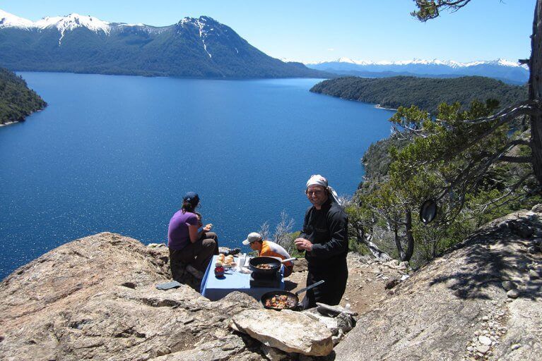 Personal chef preparing private gourmet lunch with mountain and lake views during a hike in Argentina's Lake District