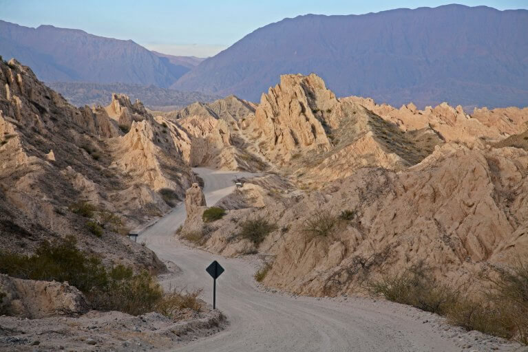 A road winds between jagged hills known as Quebrada de las Flechas near Salta during a private tour of Argentina