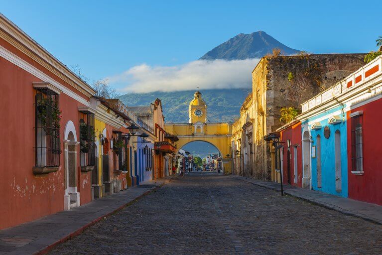 Colorful streetscape in Antigua, Guatemala with the colonial Santa Catalina Arch in the background