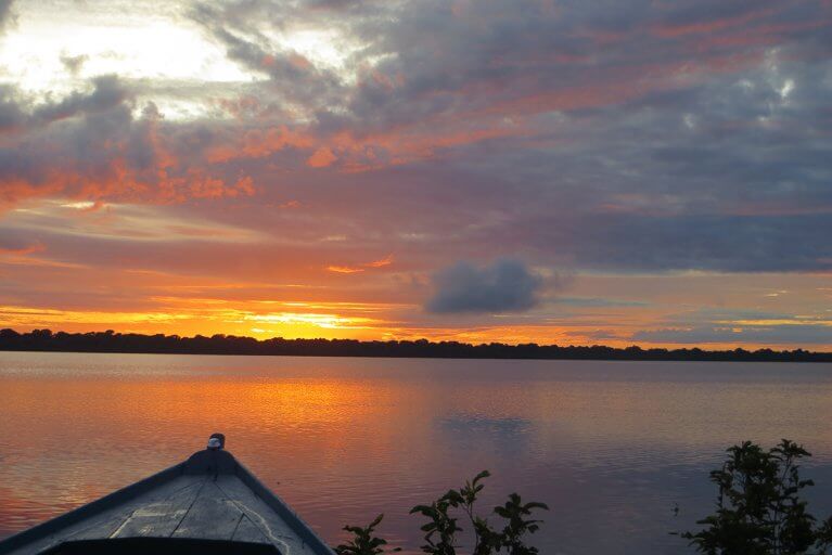 Sunset over the Amazon river from boat during a private Amazon tour
