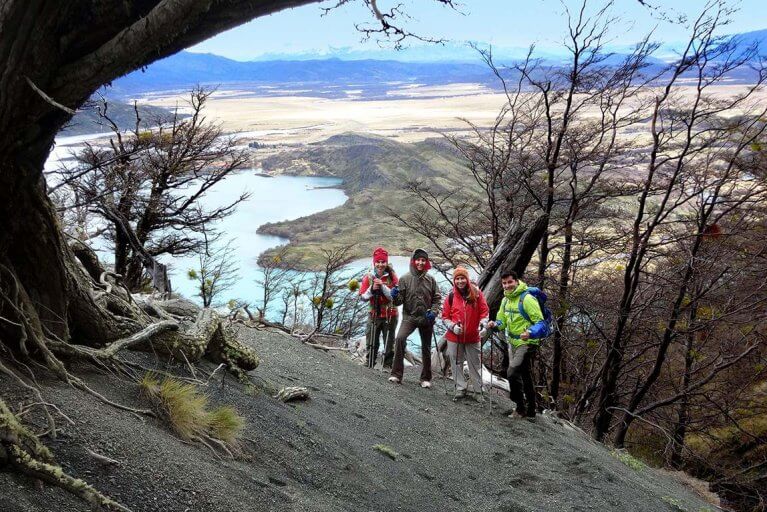 Four people hiking a mountain on a luxury tour of Patagonia, Argentina
