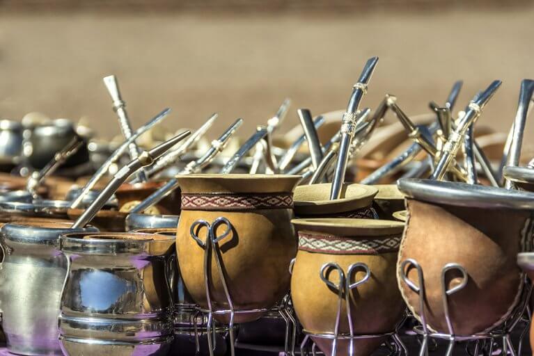 Traditional cups for yerba mate tea with metal filter straws as seen in Uruguay and Argentina