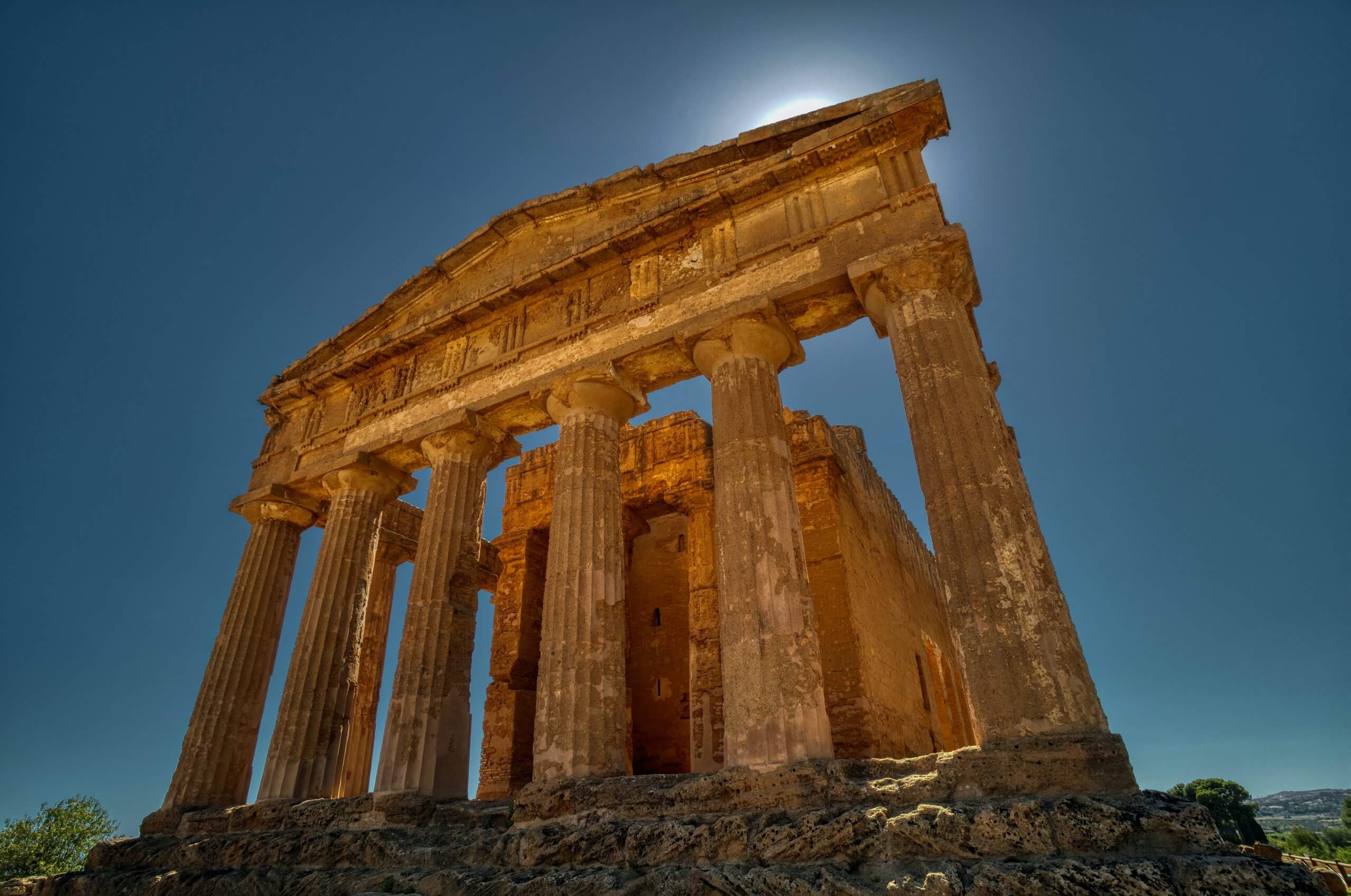 Looking up at columns of a ruined Roman temple in Valley of the Temples on a sunny day in Agrigento, Italy