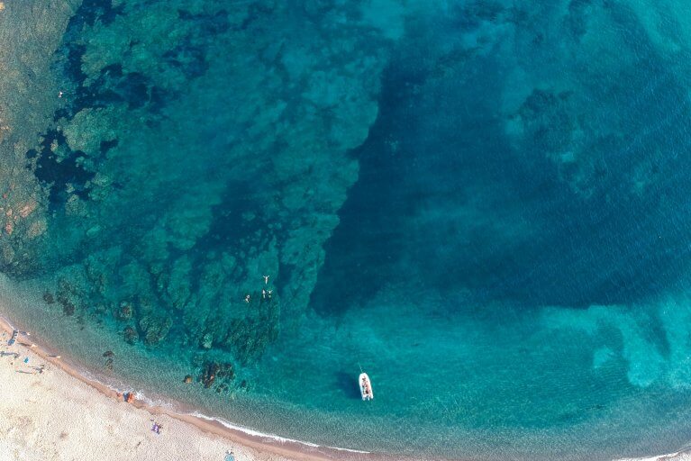 Aerial view of Rondinara Beach and clear blue sea in Corsica