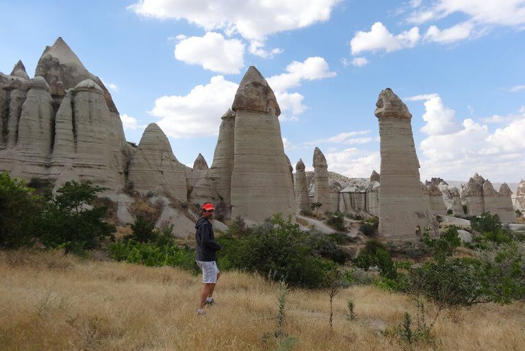 Man exploring fairy chimneys in Cappadocia, Turkey