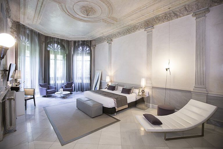 Spacious luxury suite with large windows at Palacio de los Patos in Granada, Spain