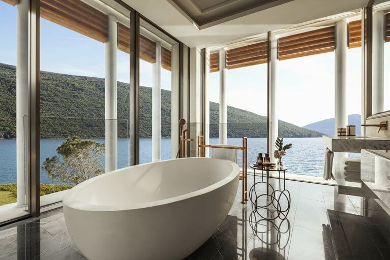 Large bathtub with sea view in bathroom of a luxury suite at One&Only hotel in Montenegro