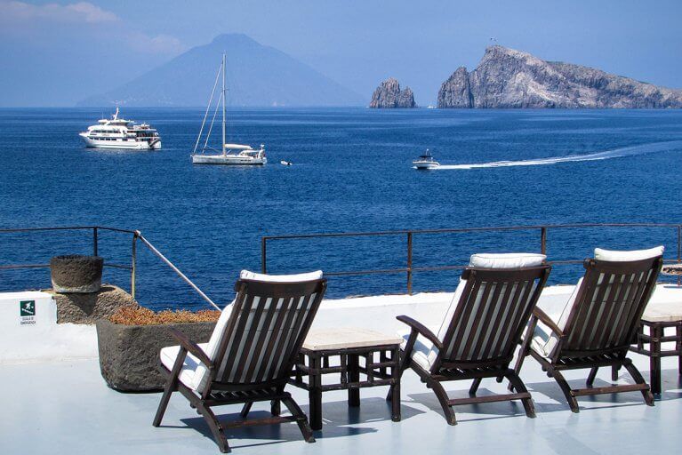 Seaside balcony with sun loungers and views of Aeolian islands across the sea