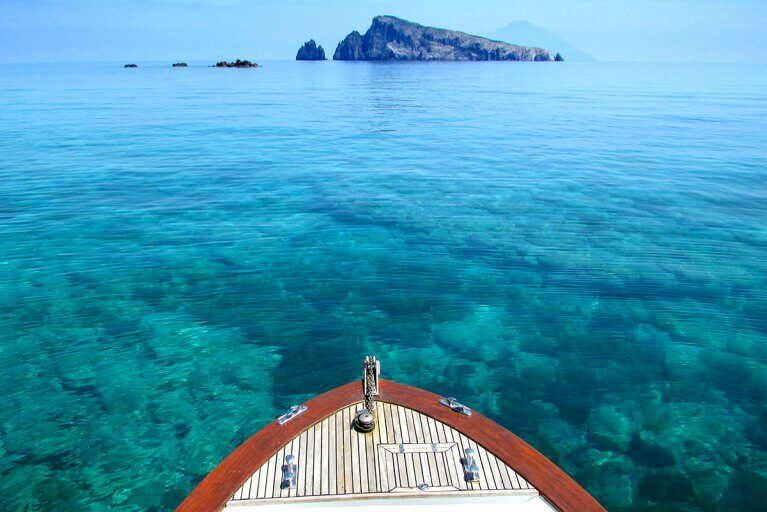 Clear blue water of the Tyrrhenian Sea with a small rocky island