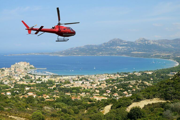 Private helicopter ride over coastal city and sea in Corsica