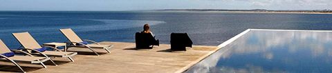 Infinity pool and deck with sun loungers with view of sea at Playa Vik luxury hotel in Jose Ignacio, Uruguay