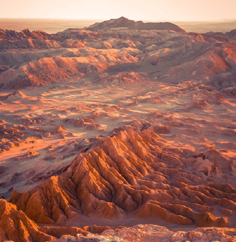 Reddish mountains and sand in Atacama Desert