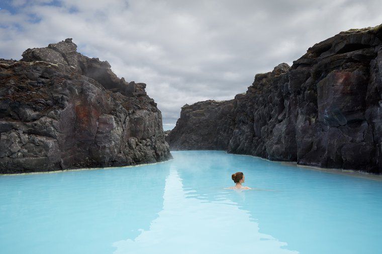 Woman swimming in the thermal springs of Iceland's Blue Lagoon