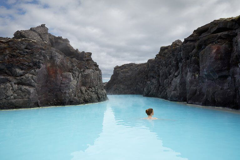 Woman swimming in the thermal springs of Iceland's Blue Lagoon