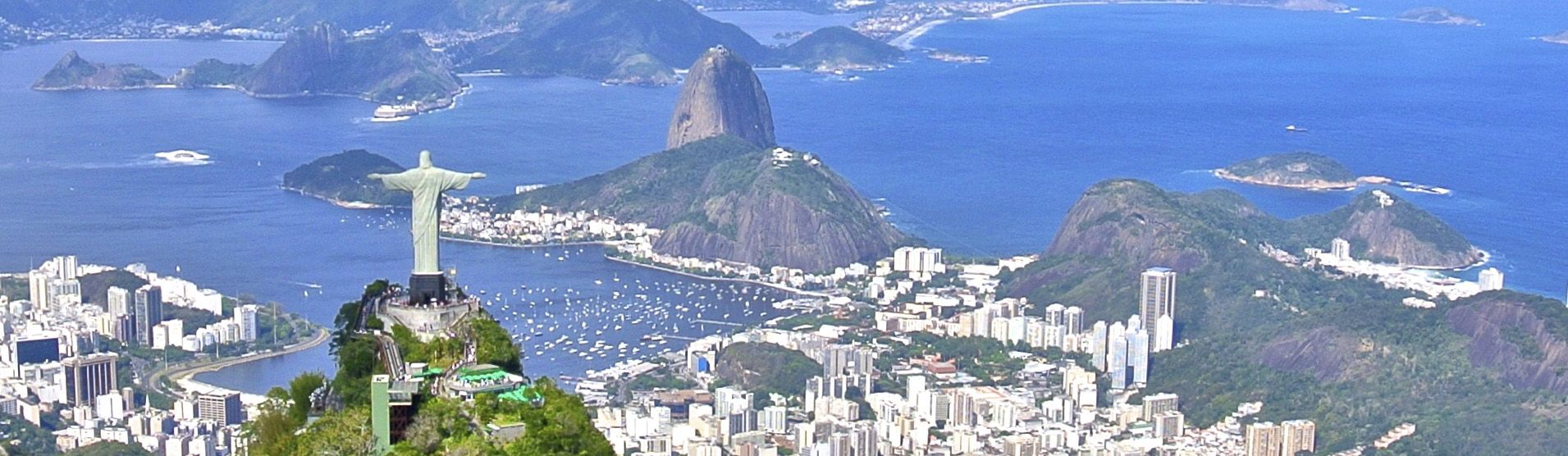 Aerial shot of Christ the Redeemer with Sugarloaf Mountain in the distance in Rio de Janeiro on a luxury Brazil tour