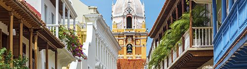 View of balconies in Cartagena's historic Old Town with the 17th century cathedral tower in the background
