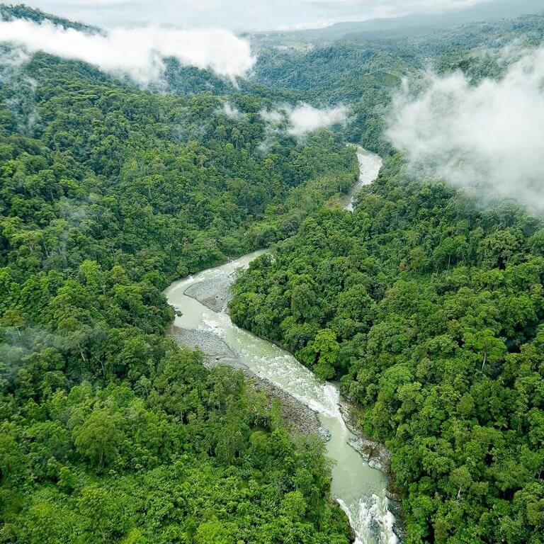 Aerial view of the Pacuare River winding through the lush rainforest of Costa Rica during a luxury tour