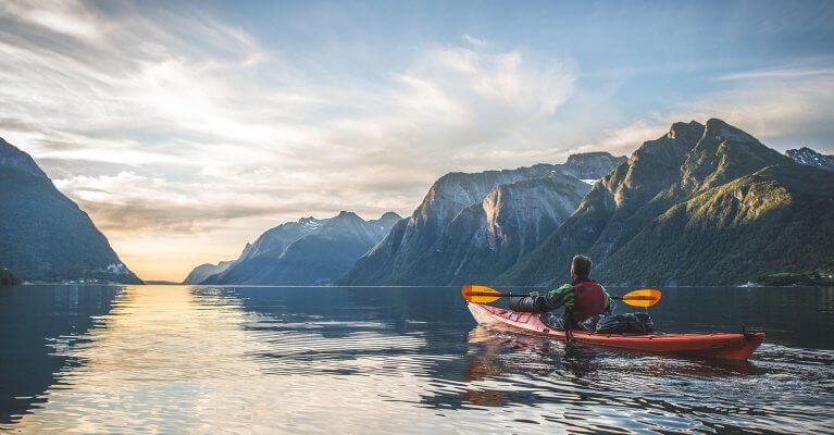 Kayaking excursion in Hjørundfjord Fjord during summer in Norway